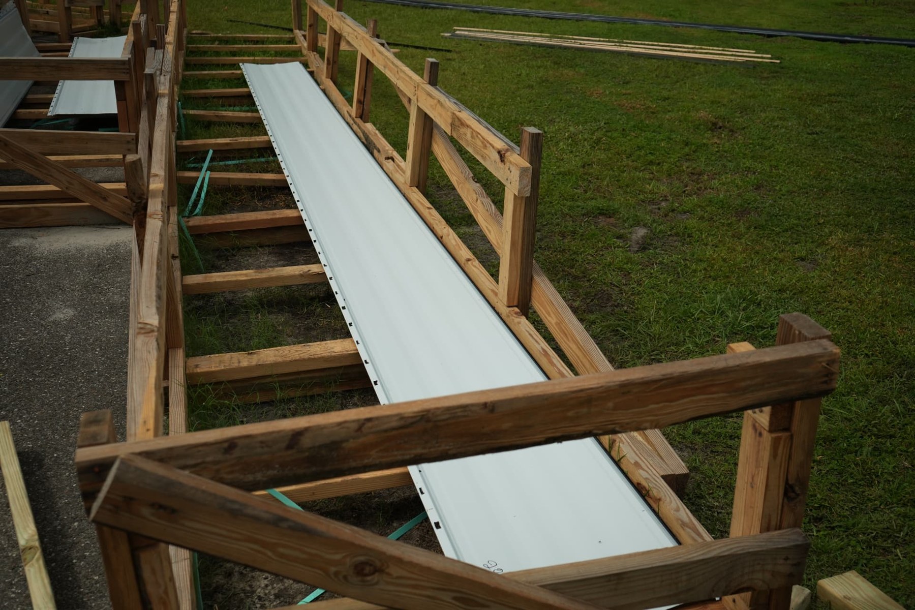 White metal roofing panel supported on wooden racks at the Kissimmee commercial job site
